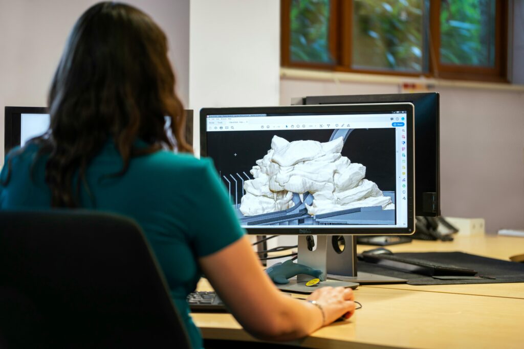 pexels photo 3862372 3862372 1 A woman using CAD software for 3D modeling in an office setting with a back view.